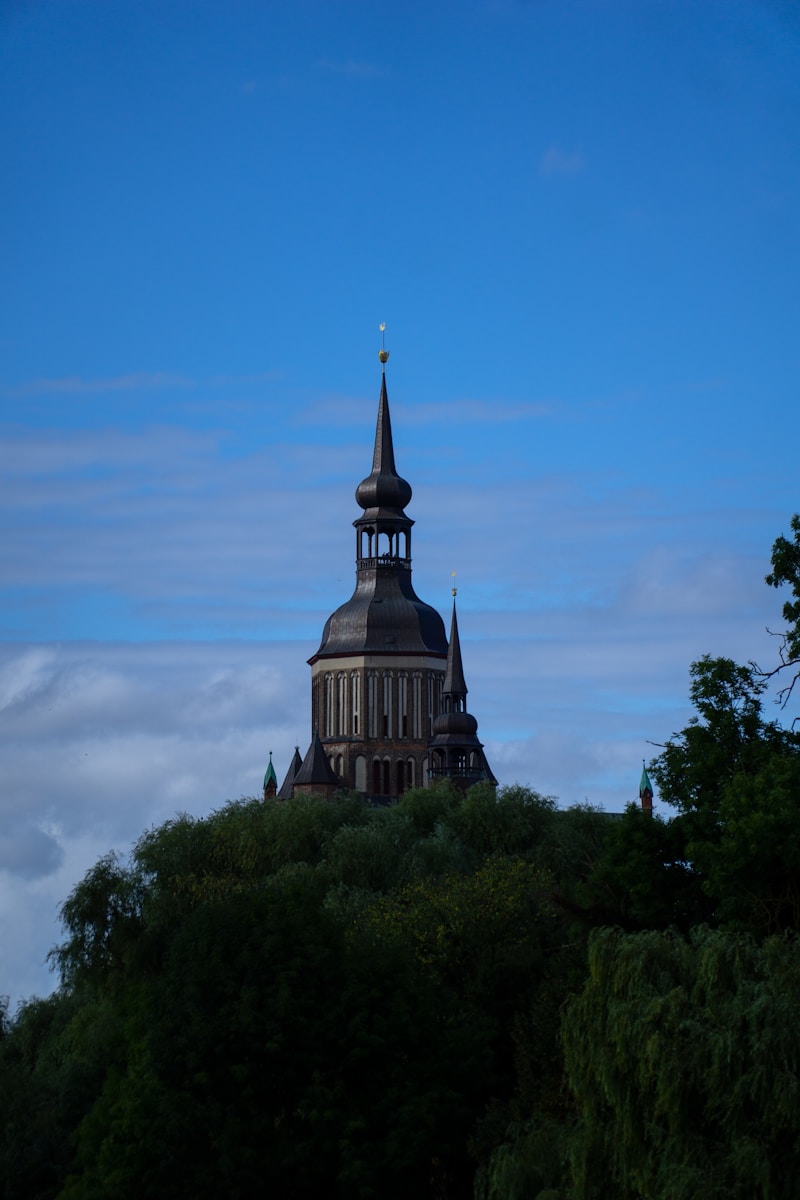 a building with a steeple on top of a hill
